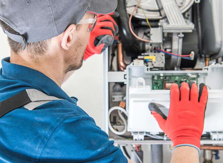 man repairing furnace